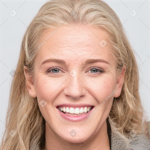 Joyful white young-adult female with long  brown hair and blue eyes