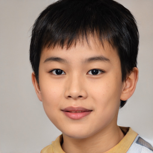 Joyful asian child male with short  brown hair and brown eyes