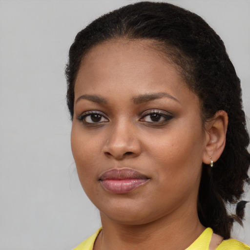 Joyful black young-adult female with medium  brown hair and brown eyes