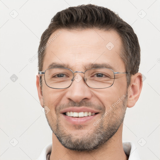 Joyful white adult male with short  brown hair and brown eyes