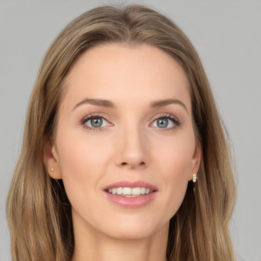 Joyful white young-adult female with long  brown hair and grey eyes