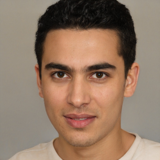 Joyful white young-adult male with short  black hair and brown eyes