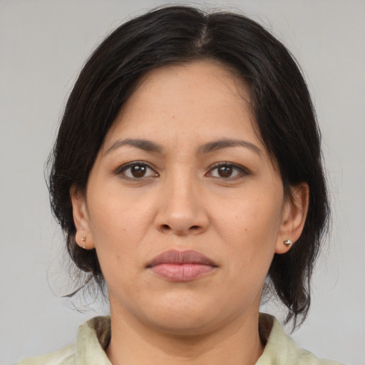 Joyful asian adult female with medium  brown hair and brown eyes