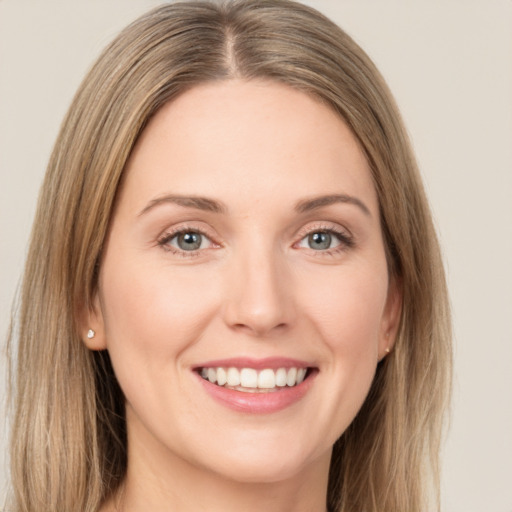 Joyful white young-adult female with long  brown hair and green eyes