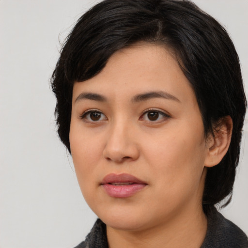 Joyful asian young-adult female with medium  black hair and brown eyes