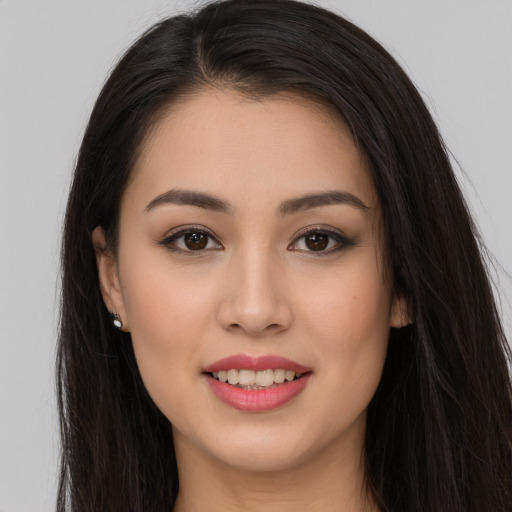 Joyful white young-adult female with long  brown hair and brown eyes