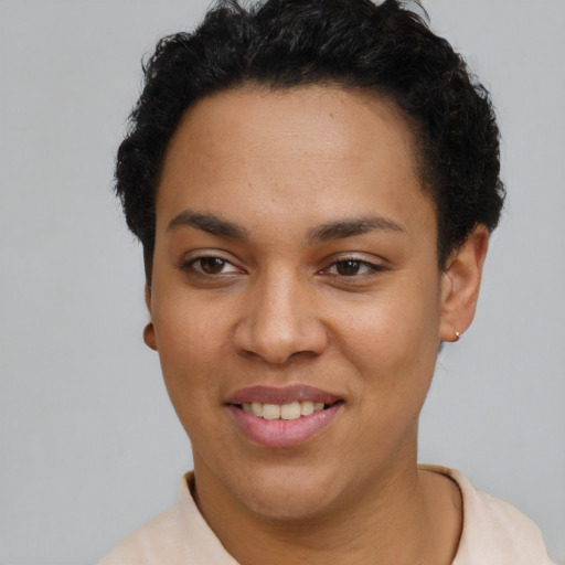 Joyful latino young-adult female with short  black hair and brown eyes