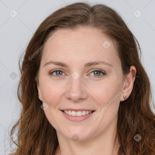 Joyful white adult female with long  brown hair and grey eyes