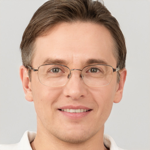 Joyful white adult male with short  brown hair and grey eyes