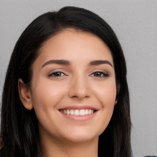 Joyful white young-adult female with long  black hair and brown eyes