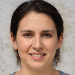 Joyful white adult female with medium  brown hair and brown eyes