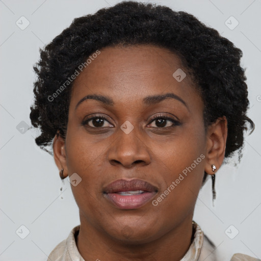 Joyful black adult female with short  brown hair and brown eyes