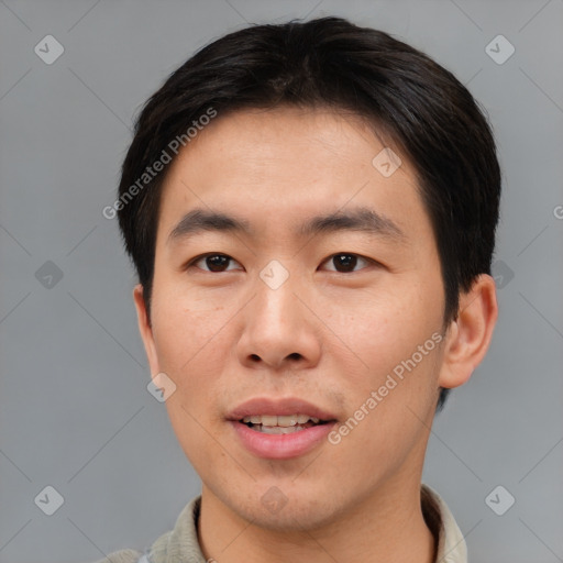 Joyful asian young-adult male with short  brown hair and brown eyes