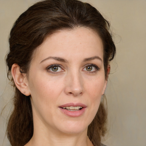 Joyful white young-adult female with medium  brown hair and green eyes