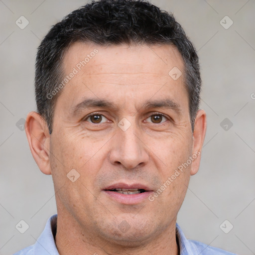 Joyful white adult male with short  brown hair and brown eyes