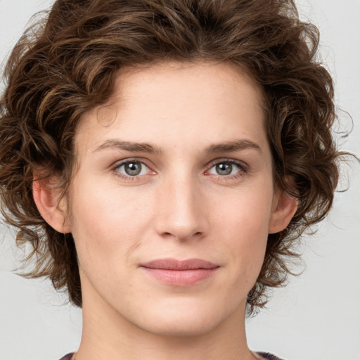 Joyful white young-adult female with medium  brown hair and green eyes