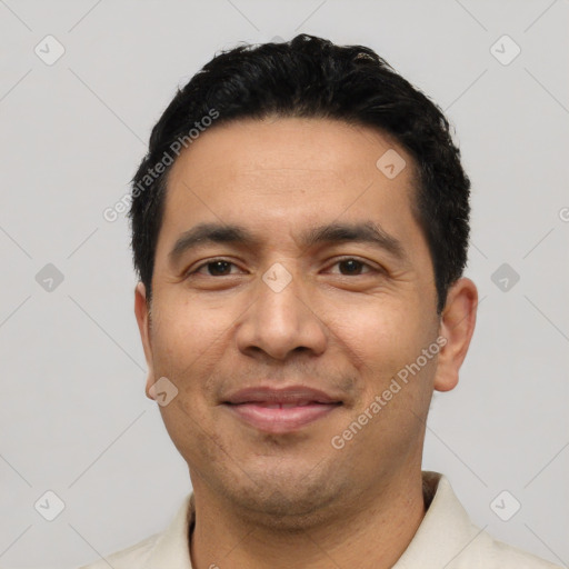 Joyful latino young-adult male with short  black hair and brown eyes