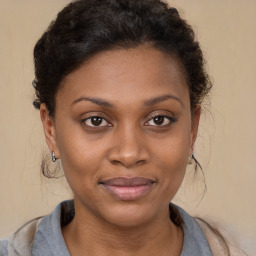 Joyful black young-adult female with medium  brown hair and brown eyes