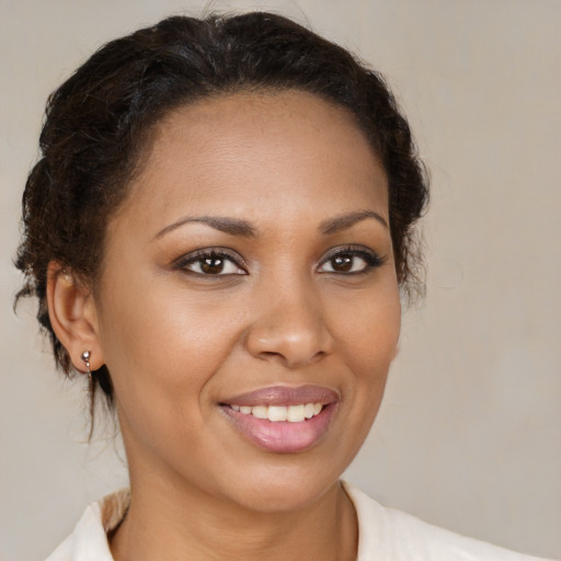 Joyful black young-adult female with medium  brown hair and brown eyes