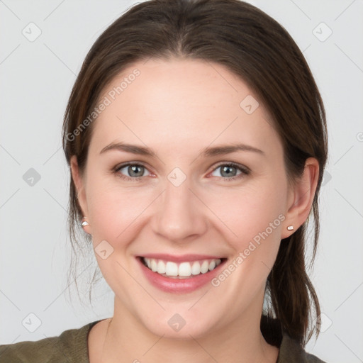 Joyful white young-adult female with medium  brown hair and grey eyes