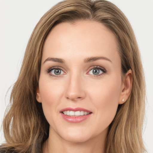 Joyful white young-adult female with long  brown hair and blue eyes