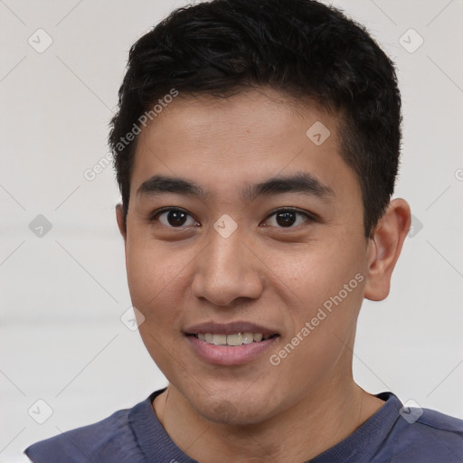 Joyful white young-adult male with short  black hair and brown eyes