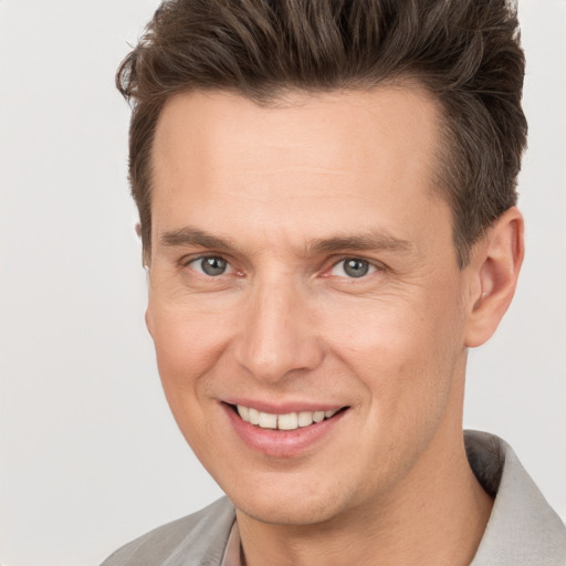 Joyful white adult male with short  brown hair and brown eyes