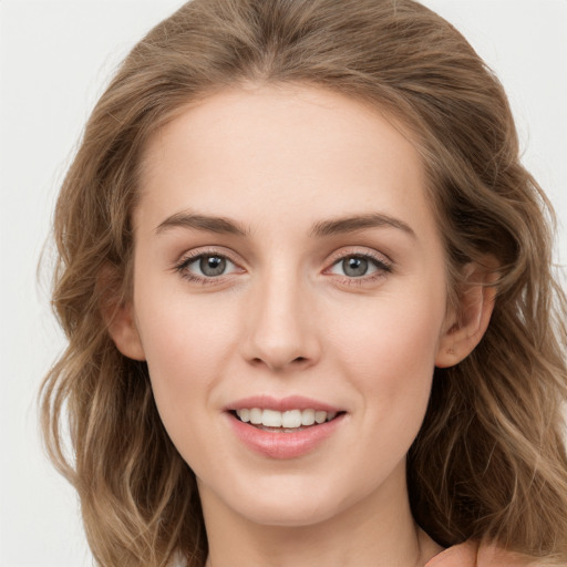 Joyful white young-adult female with long  brown hair and grey eyes