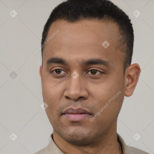 Joyful latino young-adult male with short  black hair and brown eyes