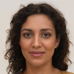 Joyful white adult female with long  brown hair and brown eyes