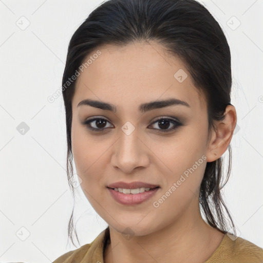 Joyful latino young-adult female with medium  brown hair and brown eyes