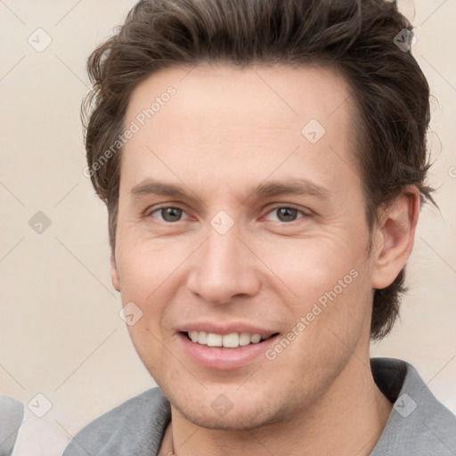 Joyful white adult male with short  brown hair and grey eyes