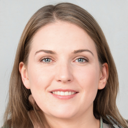 Joyful white young-adult female with long  brown hair and grey eyes