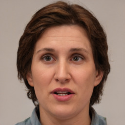 Joyful white adult female with medium  brown hair and brown eyes