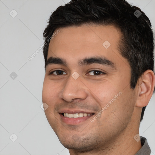 Joyful white young-adult male with short  black hair and brown eyes