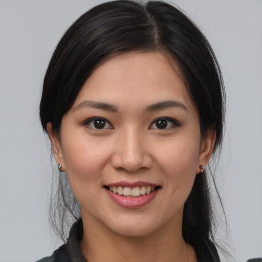 Joyful asian young-adult female with medium  brown hair and brown eyes