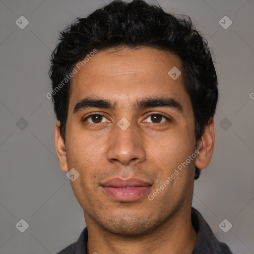 Joyful latino young-adult male with short  black hair and brown eyes