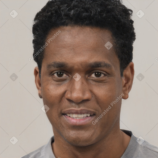 Joyful black adult male with short  black hair and brown eyes