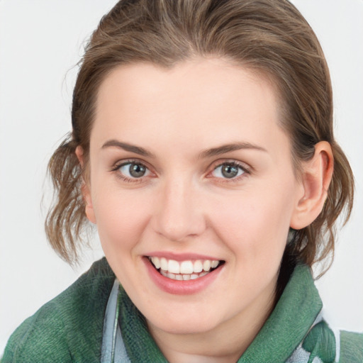 Joyful white young-adult female with medium  brown hair and blue eyes