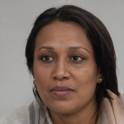 Joyful black adult female with long  brown hair and brown eyes