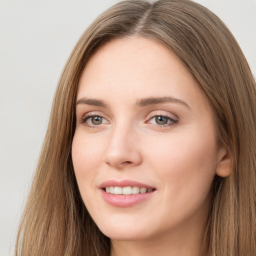 Joyful white young-adult female with long  brown hair and grey eyes