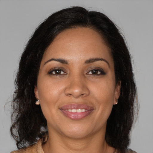 Joyful black adult female with medium  brown hair and brown eyes
