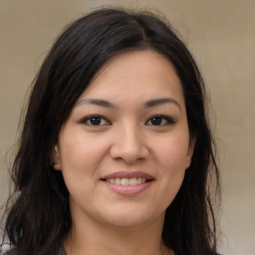 Joyful latino young-adult female with long  brown hair and brown eyes
