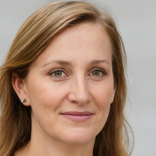 Joyful white adult female with long  brown hair and blue eyes