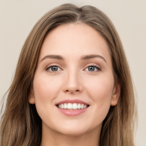 Joyful white young-adult female with long  brown hair and green eyes