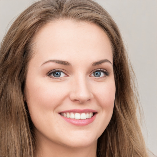 Joyful white young-adult female with long  brown hair and green eyes