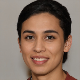 Joyful latino young-adult female with medium  brown hair and brown eyes