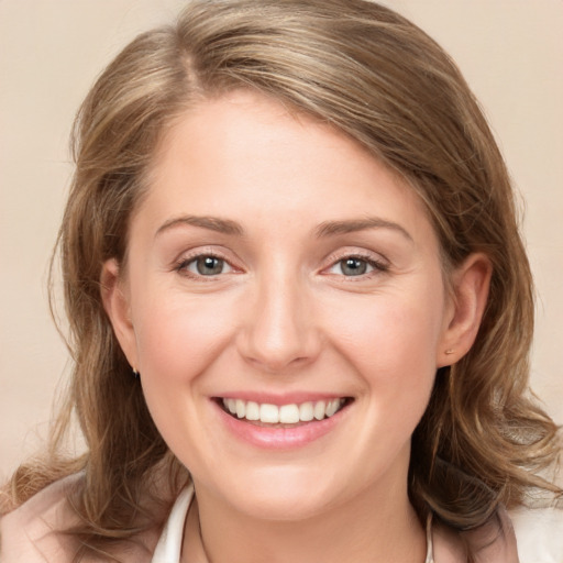 Joyful white young-adult female with medium  brown hair and grey eyes