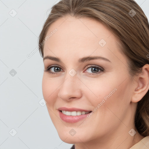 Joyful white young-adult female with medium  brown hair and grey eyes