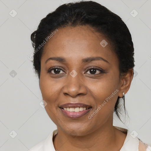 Joyful black adult female with short  black hair and brown eyes